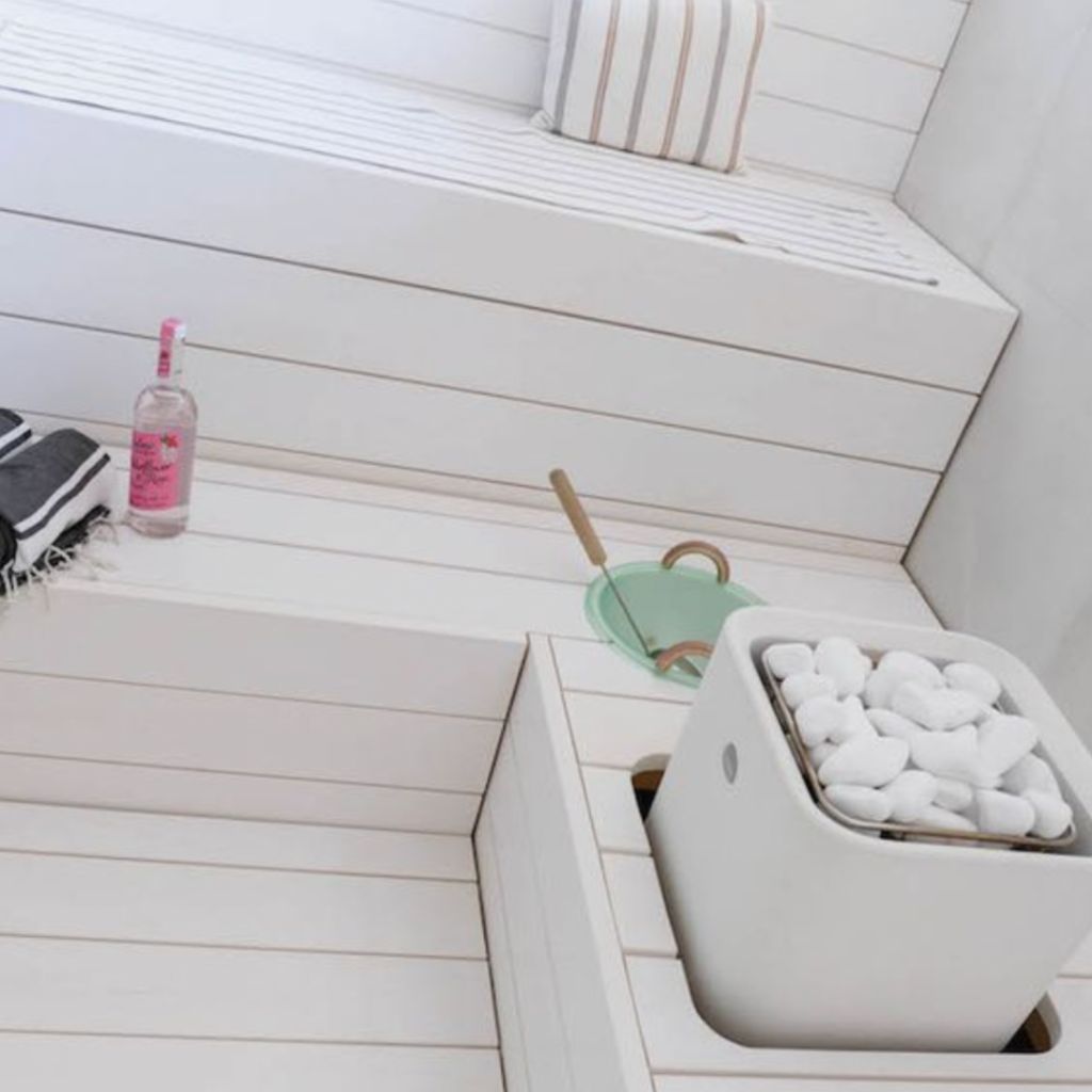 All-white sauna with white sauna stove and white sauna stones